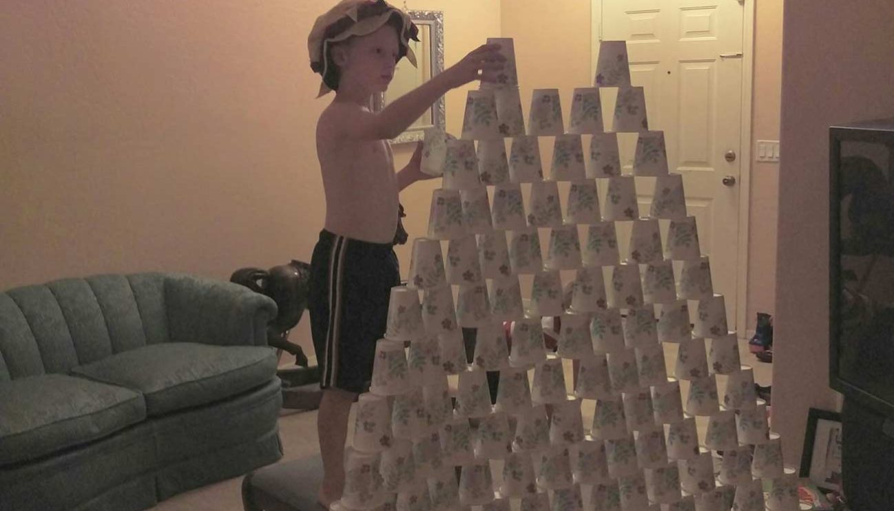 Stacking paper cups into a pyramid Stacking paper cups into a pyramid