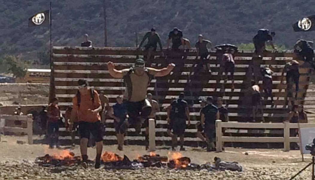 Jumping over the fire at the finish line at the SoCal Spartan Sprint Jumping over the fire at the finish line at the SoCal Spartan Sprint