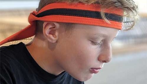 Matt wearing his orange belt as a headband Matt wearing his orange belt as a headband