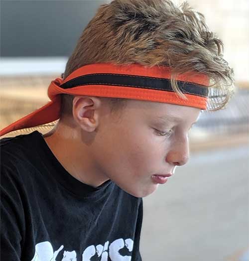Matt wearing his orange belt as a headband